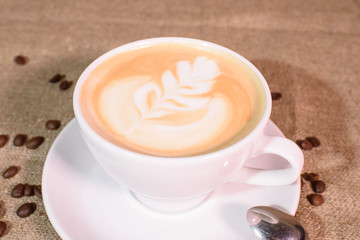 Tasty and fragrant cappuccino on the background of the canvas.