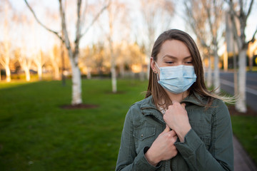 Coronavirus, masked girl on an empty street in USA. The title is about an outbreak of a coronavirus virus in China, an illness. epidemic