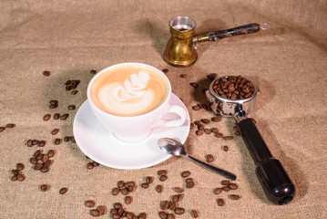 Tasty fragrant caupchino on a canvas background. Near the Turk and the holder.