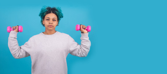 woman doing gymnastics with aerobics weights isolated on color background