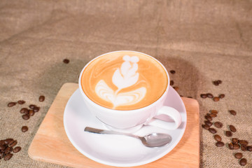 Tasty and fragrant cappuccino on the background of the canvas.