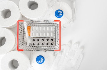 Shopping basket with medicines, tablets and anti-virus mask. Stocks of dry food and toilet paper