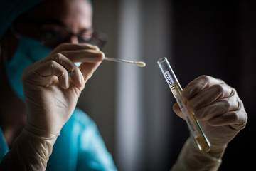 Doctor holding a coronavirus COVID-19 test tube