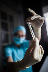 Doctor hands holding a coronavirus COVID-19 positive test tube