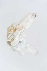 Crystal Stone macro mineral, white rough quartz crystals on white background