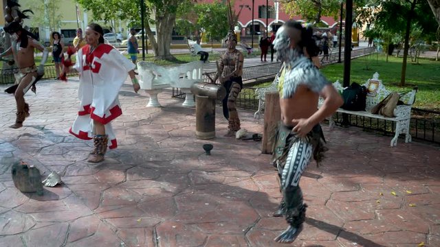 Mayan dancers performing to live drums outside in a park in Valladolid, Mexico.