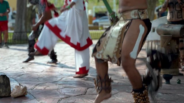 Closeup of Mayan dancers legs performing to live drums outside in a park in Valladolid, Mexico.