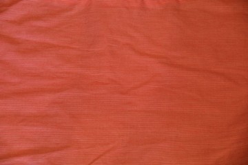 Crumpled red pinstripe fabric texture