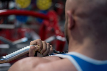 Hard Core Bodybuilding. Muscular athletic bodybuilder fitness model training arms with dumbbells in gym. Concept sport photo of exercises in gym