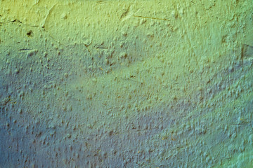 Green gradient paint on a stucco scratched wall. Close-up of a graffiti texture. Street art background.