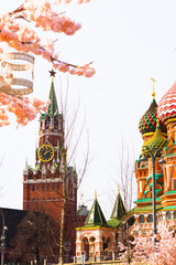 Moscow, Russia, April 16, 2018 - St. Basil's Cathedral, the Kremlin and Vasilyevsky Descent in the spring surrounded by artificial sakura trees, installation. - 332764407