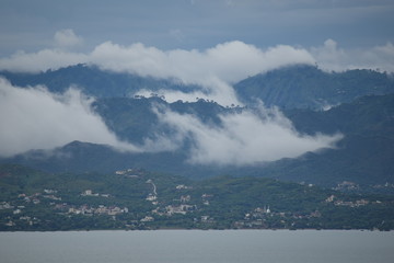 Beautiful view of dam and mountains with clouds after rain