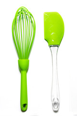 Set of green silicone culinary spatula and whisk Isolated on white background