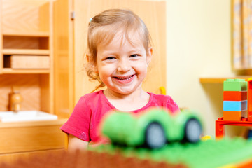 Little girl playing with a toy car