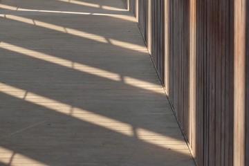 A line of high modern building on the path floor with sunlight shadow for background texture