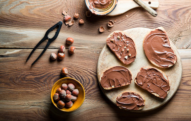 Sandwiches with chocolate cream on wood.