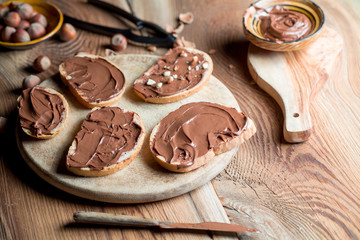 Sandwiches with chocolate cream on wood.