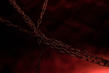 metal chains on a black-red background, bdsm accessories