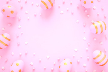 Pink Easter background with decorated eggs and beads. Place for text.