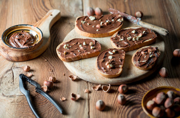 Sandwiches with chocolate cream on wood.