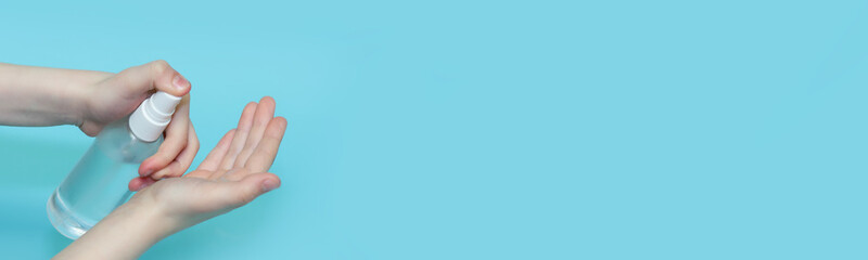 A child sprinkles an antiseptic on his hands. Virus protection. The use of chlorhexidine to protect against viruses and bacteria.Banner