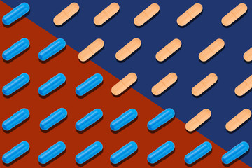 Seamless pattern with blue and orange pills on red and blue background.
