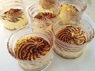Sweet, creamy cream sprinkled with grated chocolate in cups.