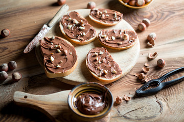 Sandwiches with chocolate cream on wood.