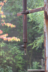 rusted pipeline with shut-off valve in a disused factory