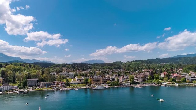 
Aerial drone view of hotel Falkensteiner Schlosshotel Velden Am Worthersee lake and cruise ship, mountain view on a sunny day in Austria