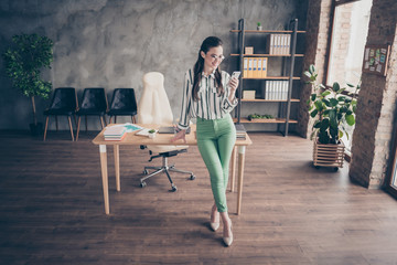 Full size photo of positive smart leader business lady girl use smartphone texting typing chatting...