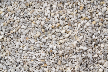 Road gravel, crushed stone. Gravel texture. Crack stones at a construction site. Seamless texture of white stones or gravel