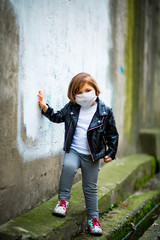 little girl on a walk in a medical mask