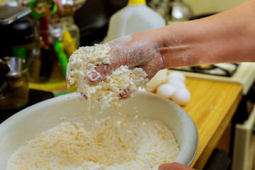 Woman making dough for baking cheese bread called chipa.