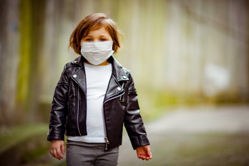 little girl on a walk in a medical mask