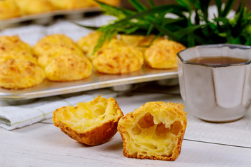 Chewy cheese bread called chipa with coffee on wooden table.