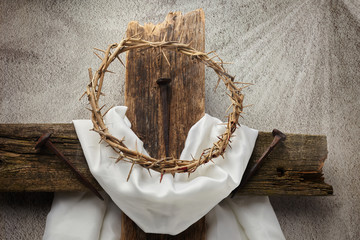Easter background depicting the crucifixion with a rustic wooden cross, crown of thorns and nails.