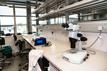 White microscope stands in laboratory on table