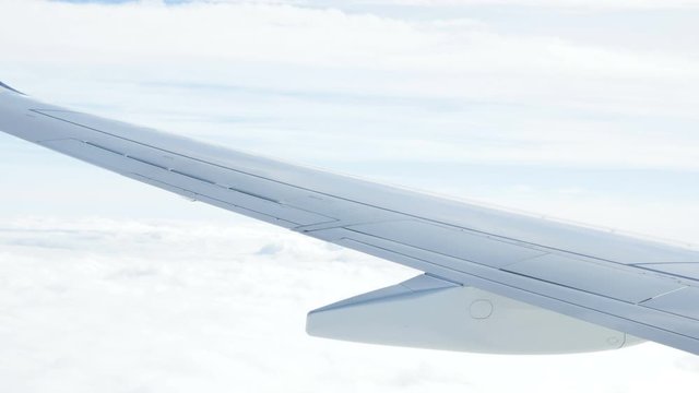 airplane wing flying in clouds