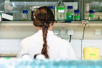 Close up of back of female scientist in laboratory