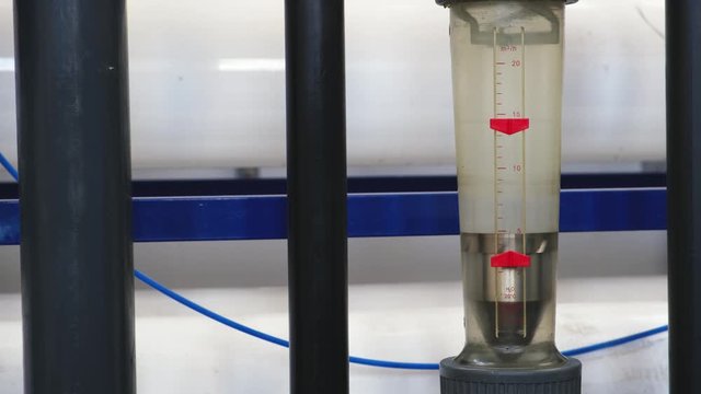 rotameter, measures volumetric flow rate of water in closed tube, part of wastewater treatment facilities, filtration or purification, close up view  