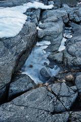 Ice on a cliff with cracks and shadow