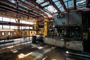 Old rusty Industrial tanks connected by pipes connected with valves in abandoned chemical factory