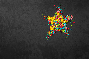 Sprinkle star shape background. Sprinkle in the form of stripes, balls, stars on a black background. copy space. concept of an Easter plan. top view photo