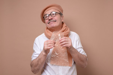 man holding a piece of bubble wrap in his hand trying to relax and do not worry.