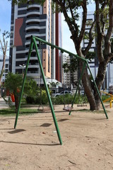 Swing in playground at Jose Barreto square in Maceio Brazil