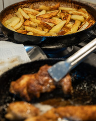 Making chicken schnitzel and french fries in the home kitchen