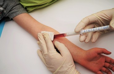 Doctor gives an injection to a small child