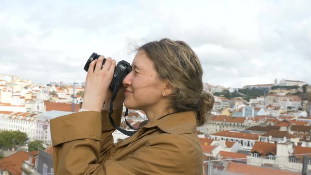 happy tourist enters the frame on observation deck and takes photos