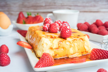Condensed milk flan with raspberries and strawberries.